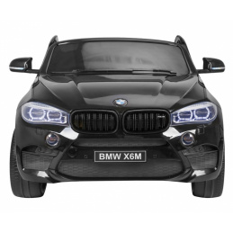 BMW X6M XXL za 2 djece Lak crna + Daljinski upravljač + Eko koža + Sigurnosni pojasevi + Spori start + MP3 + LED